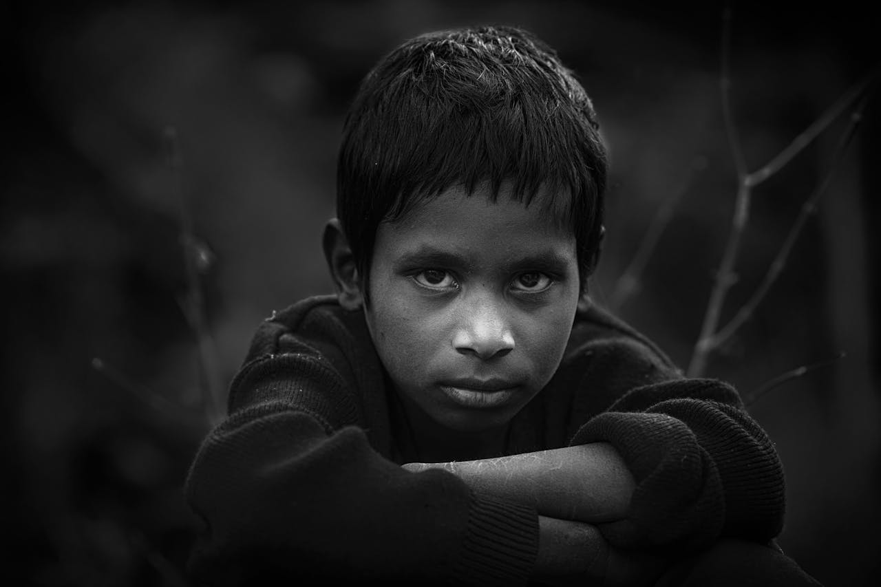 Black and white portrait of a young boy in Sheoganj, India, with intense expression.